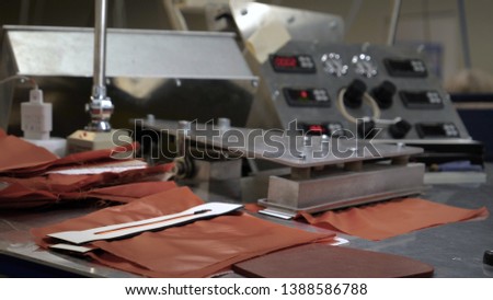 In a garment factory, women press (cut) various pieces of clothing and fabric. Use various materials using different machines. 