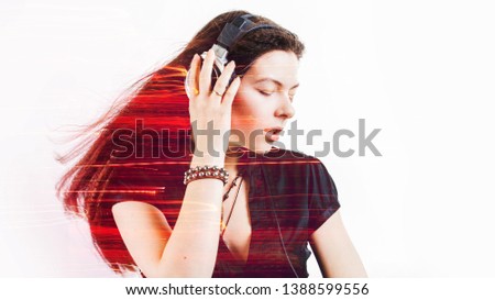 Girl fan sings and dances listening to music. Young brunette woman in big headphones enjoys music, double exposure, concept