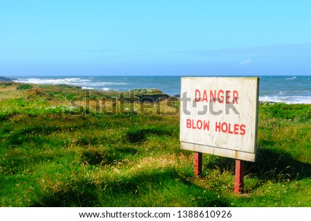 Sign warning of the presence of blow holes along coastal rocks