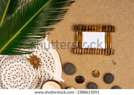 Vacation background concept and photo frame on sand. top view.