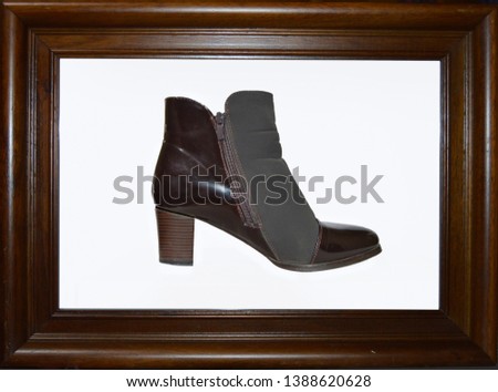 A shoe framed in a wooden frame