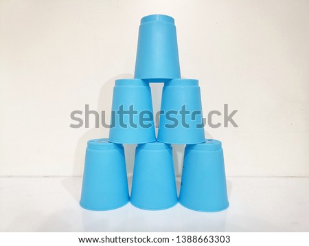 6 Blue stacking cups on white table and white background