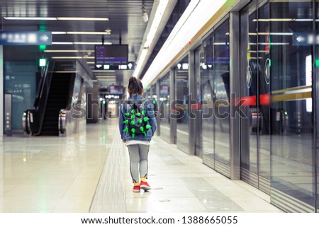 Lovely little Asian girl in the subway station