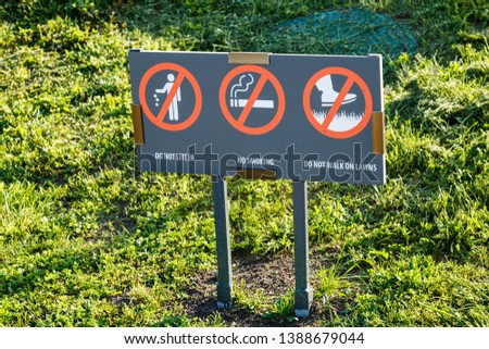 Don't litter Sign. Do not walk on the lawns Sign. No smoking sigh in the city