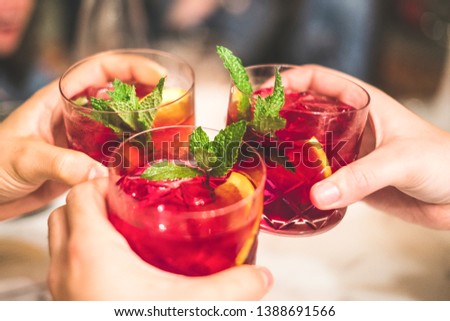 Friends toasting with sangria in a Spanish restaurant.  Royalty-Free Stock Photo #1388691566