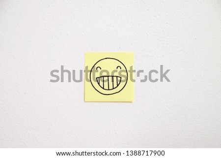 Drawing of smiling face on sticky paper