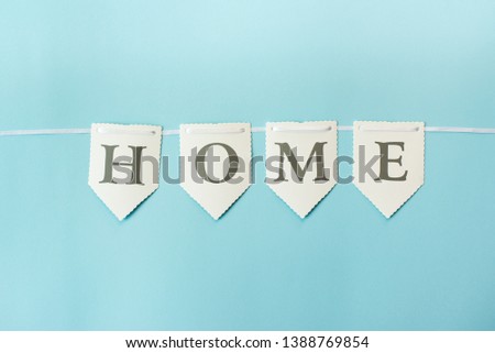 Word home on pastel blue background, top view with copy space . Family concept