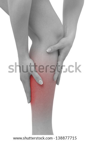 Acute pain in a woman calf. Female holding hand to spot of  calf-aches. Concept photo with Color Enhanced blue skin with read spot indicating location of the pain. Isolation on a white background. 