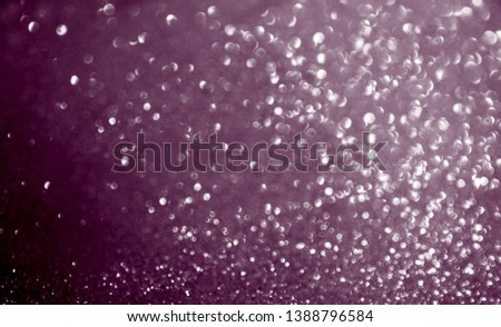 Deep purple fairy blurred festive background. Sparkling glittering backdrop for design.