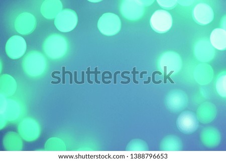 Abstract blurred green and blue sparkling festive bokeh background