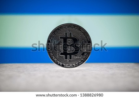 Physical silver version of Bitcoin (BTC) and Nicaragua Flag on the background. Conceptual image for investors in cryptocurrency and Blockchain Technology.