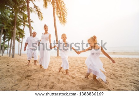 Happy young family on the sunset at the beach. Lifestyle