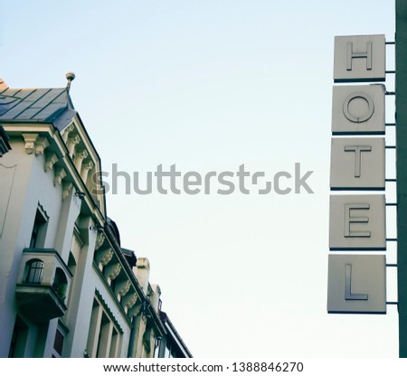 Neon Sign with the word Hotel under blue sky