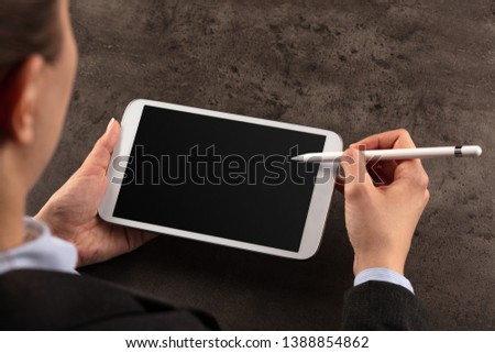 Business woman working on empty tablet with pencil