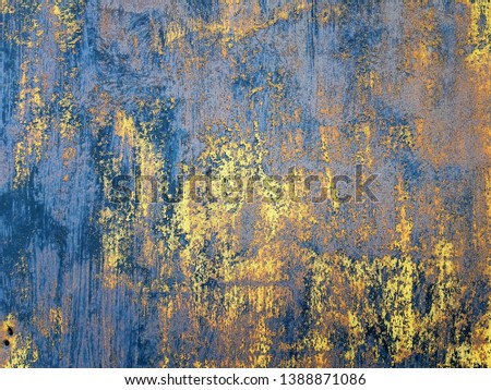 Old yellow paint on a weathered wall.