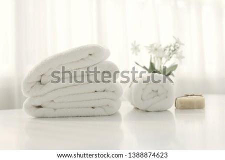 Beautifully folded white towels and toiletries. Luxury bedroom in the bedroom