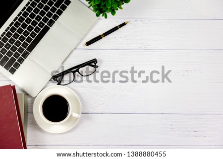 Workspace in office , Wooden White desk with blank notebook and other office supplies,Top view with copy space.