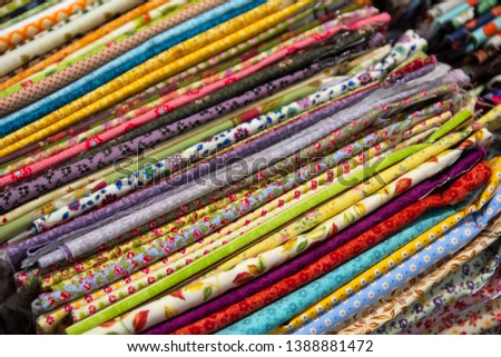Multicolored textiles on the counter of the store