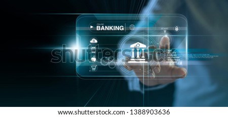 Businessman touching icon online banking and icon network connection, online payments, shopping and digital technology business on virtual screen dark blue background. Royalty-Free Stock Photo #1388903636