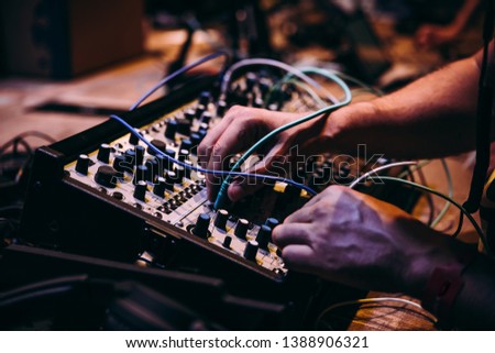 Making music using modular synthesizers. Electronic music and professional music equipment concept. Royalty-Free Stock Photo #1388906321