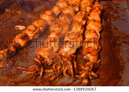 squid satay, the trend of street food from Indonesia, grilled squid with a sprinkling of sweet spices