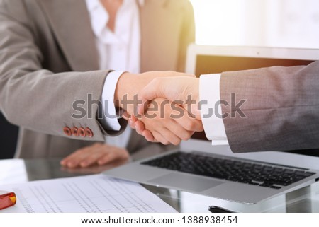 Business handshake after contract signing. Two women shaking hands after meeting or negotiation
