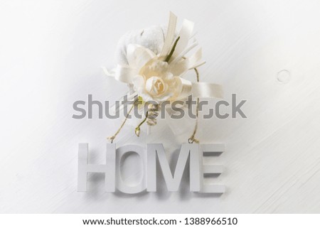 Nordic style still life on a white wooden background with wooden letters with the inscription Home, the concept of home or home purchase