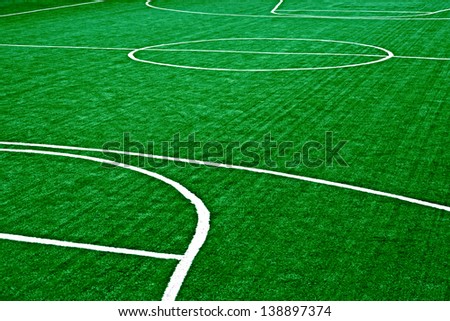 Sports field with synthetic turf and different markings, used in sports.