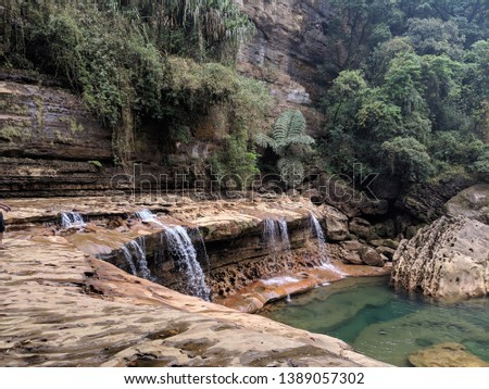 Nohkalikai falls, Meghalaya. The curved rocks formation due to intense flow of water over the years is captured in this picture.