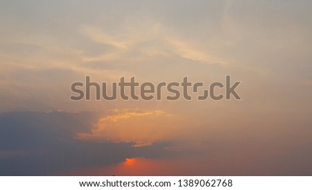 The image of the sunset in the sky