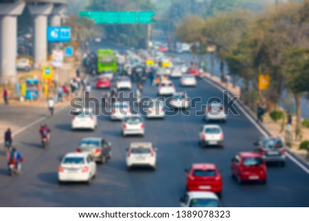 Defocused Picture of India Road Street with Cars, Mopeds and Rickshaws  in New Delhi as Background