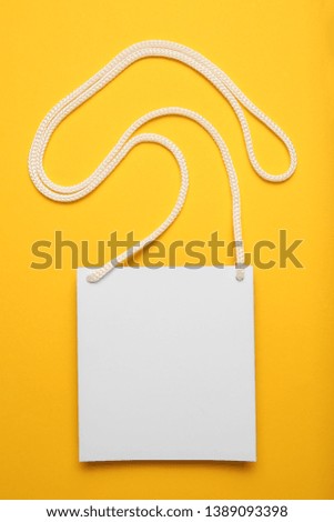 Name tag badge on yellow background, isolated convention card blank.