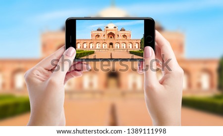 Taking a photo with mobil phone of Humayun's tomb, Top sights of New Delhi, India