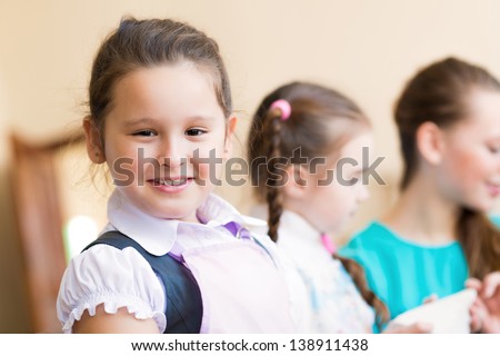 Portrait of Asian girl in apron interested in painting at an art school