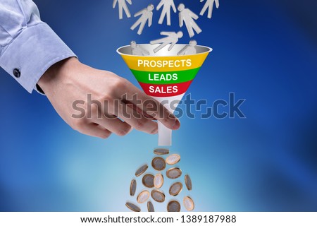 Close-up Of Businessman Holding Funnel Converting Prospects Into Money Royalty-Free Stock Photo #1389187988