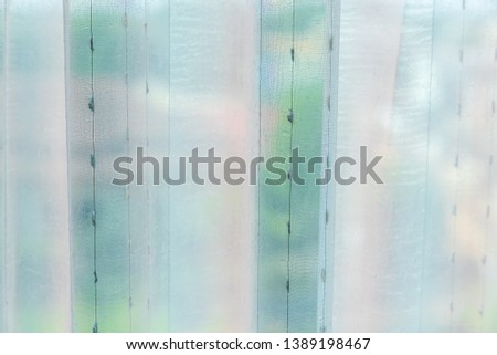 Plastic curtain surface in white and green tones in the bathroom. There is space for text. Suitable for use as a background image.
