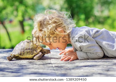 lovely happy boy with turtle