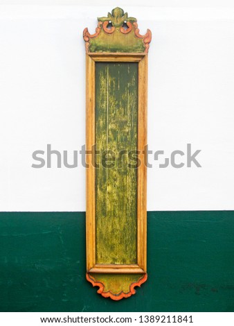 empty wooden sign isolated on white and green wall