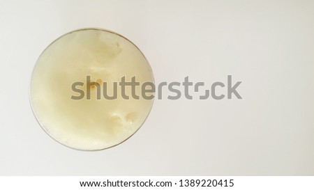 Foamy Beer Glass on White Table