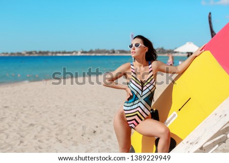 A gorgeous tanned leggy girl posing at a surf in California.