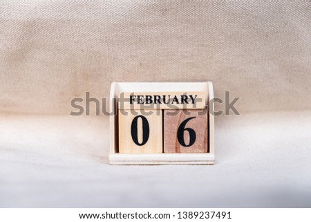 February 6th. Image of Feb 6 wooden color calendar on white canvas background. empty space for text