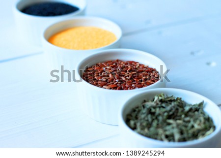 herbs, cereals and seeds in a bowl on a gray concrete background, nutrition concept