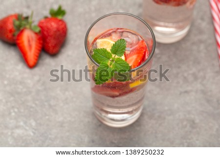 Refreshing Ice Cold Strawberry Lemonade on grey table