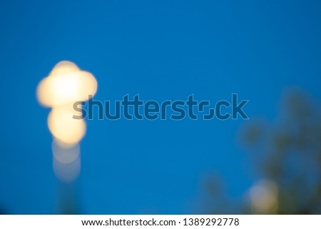 Orthodox cross on the dome of the Church against the blue sky with blur and bokeh effect, abstract background