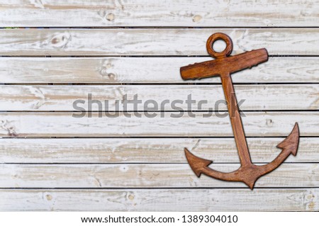 Wooden ancor on the white wooden texture background
