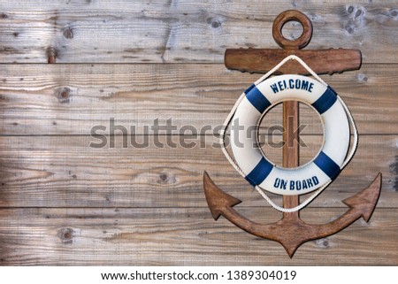 Wooden ancor and life bouy on wood pattern old nature table board 