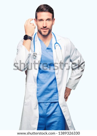 Handsome doctor man wearing medical uniform over isolated background Doing Italian gesture with hand and fingers confident expression