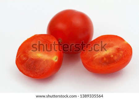 Cross section of cherry tomatoes on white background, closeup
