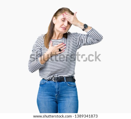 Middle age mature beautiful woman wearing stripes winter sweater over isolated background Touching forehead for illness and fever, flu and cold, virus sick