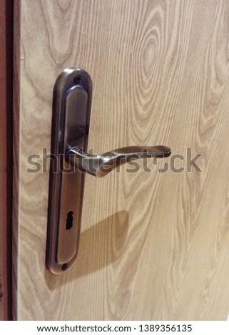 Old copper door handle (doorknob) with lock in the interior